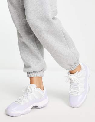 JORDAN AIR 11 RETRO LOW SNEAKERS IN WHITE AND PURPLE