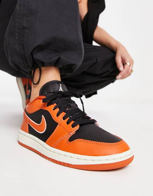 Jordan AJ1 Low trainers in orange and black