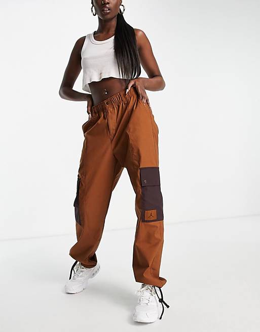 Women Jordan essential utility pants in brown with drawstring cuffs 
