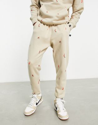 Jordan unisex essential joggers with all over logo in rattan - ASOS Price Checker