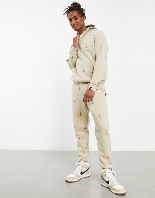 Jordan unisex essential joggers with all over logo in rattan ASOS