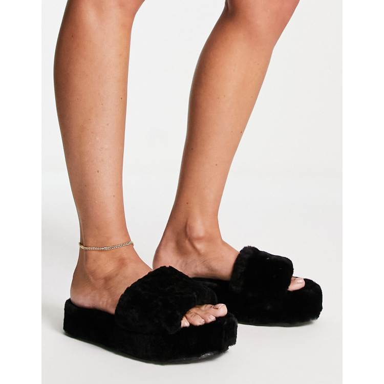 Juicy Couture stacked faux fur sliders with metal plaque in black