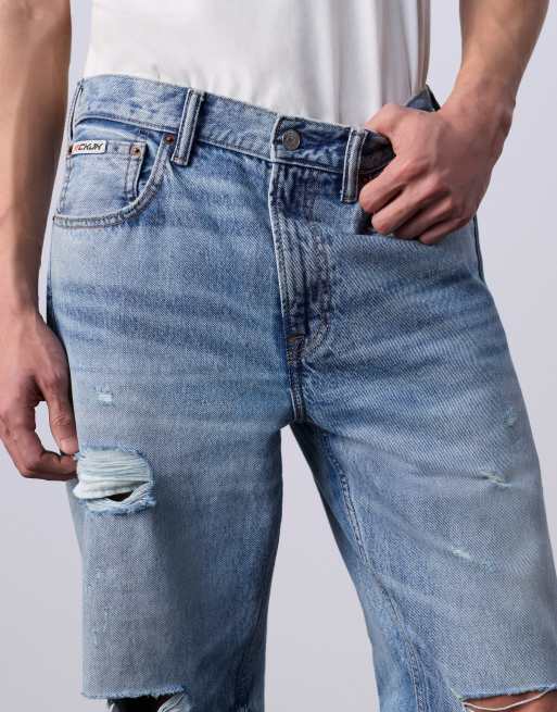 Jung Kook for Calvin Klein 90s straight leg jeans with rips in