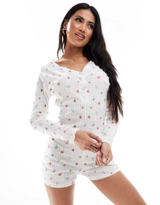 Kaiia - Ajourgebreide all in one unitard met knoopsluiting in crème met fijne print