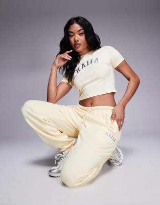 Kaiia cotton blend embroidered logo cuffed sweatpants in soft yellow and dark gray - part of a set