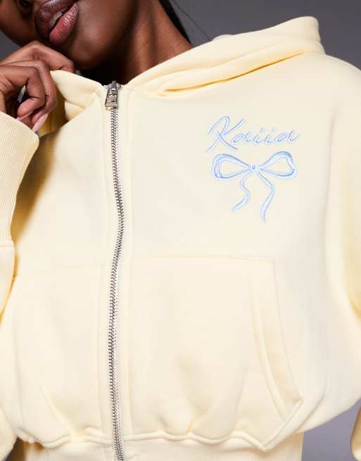 Kaiia cotton rich embroidered bow logo cropped zip through hoodie co-ord in lemon and blue, 4 of 4