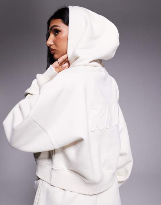 Kaiia – Cropped-Oversize-Kapuzenpullover mit hohem Baumwollanteil in milchigem Hellbeige mit Bubble-Logoprägung, Kombiteil  , 4 von 4