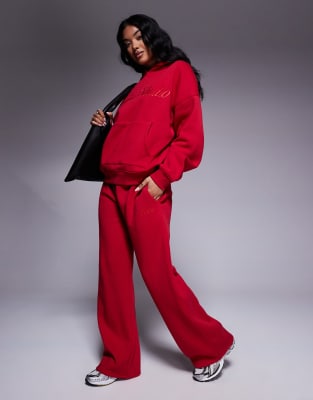 embroidered script logo wide leg sweatpants in red - part of a set