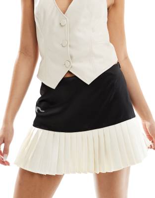 exclusive pleated contrast hem mini skirt in black and cream