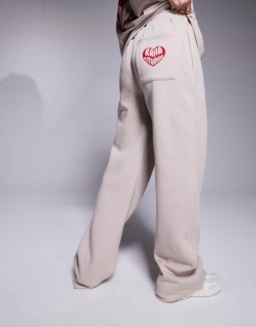 Kaiia heart back pocket logo trackies in stone and red (part of a set)