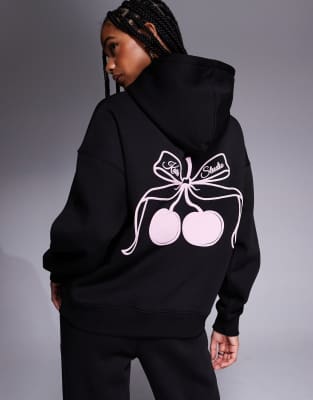 Kaiia - Kapuzenpullover in Schwarz und Rosa mit Kirschen-Schleifen-Print auf dem Rücken, Kombiteil