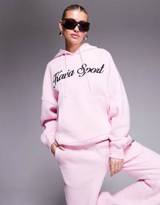 Kaiia - Sport - Kapuzenpullover aus Baumwollmix in Rosa mit aufgesticktem Schriftzug-Logo in Schwarz, Kombiteil