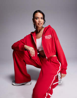 studio running club cropped zip up hoodie in red - part of a set