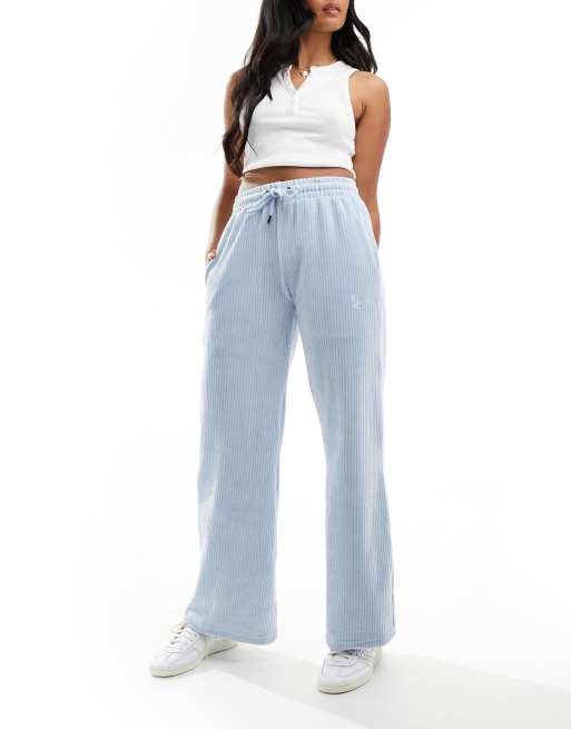 Karl Kani - Corduroy broek met wijde pijpen en klein geschreven logo in lichtblauw