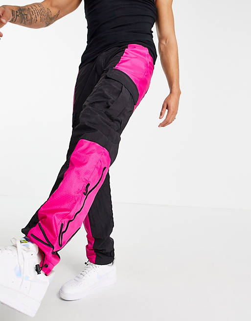 Men Karl Kani signature cargo trousers in black/pink 