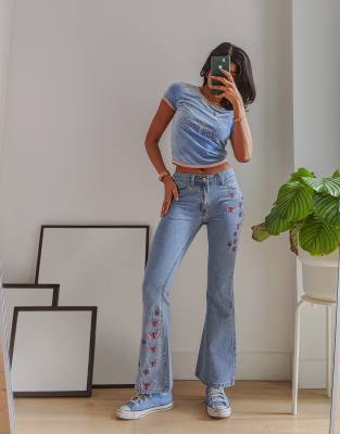 Labelrail x Pose and Repeat mid rise 90s flared jeans with butterfly appliques in blue