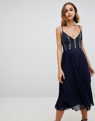 Lace & Beads – Marinblå klänning med utsmyckat liv och plisserad kjol