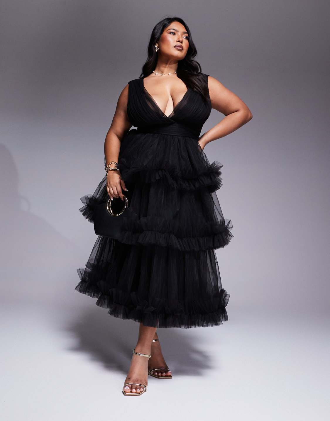 A plus-size black tulle midi dress with a ruffled skirt