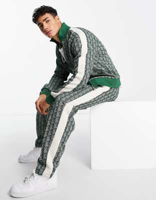 all-over print taped track pants in green