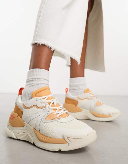 Lacoste Facilite sneakers in white and light pink