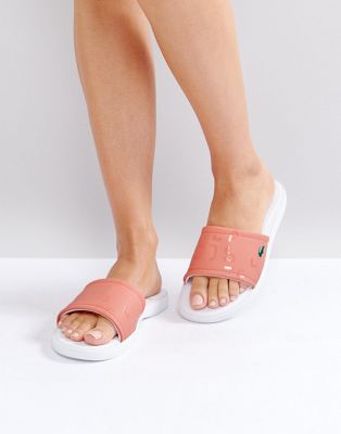 white and pink lacoste sliders