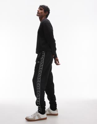 Lacoste logo stripe joggers in black