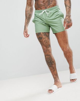 Lacoste solid logo swim shorts in green 