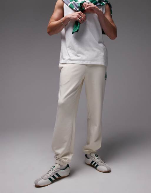 Lacoste sweatpants in white with tennis emblem