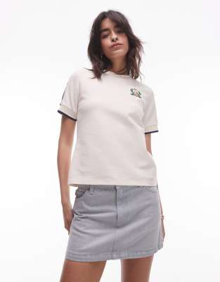 Lacoste - T-Shirt in Wollweiß mit Zierstreifen am Ärmel und Tennis-Emblem