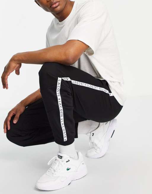 Lacoste taped zip through sweatpants in black | ASOS