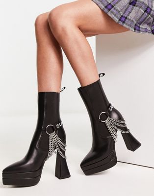 Crown heeled platform boots with chain detail in black