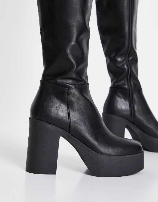 Black knee high store boots with thick heel