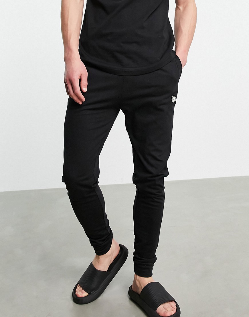 Le Breve lounge cuffed sweatpants in black with red band - part of a set
