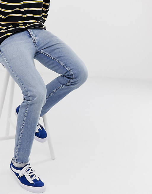 Levi's 501 slim tapered low rise jeans in revolution mid wash | ASOS