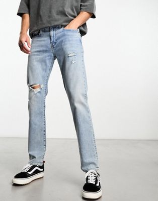 Levi's 502 tapered fit jeans in light blue wash with rips - ASOS Price Checker