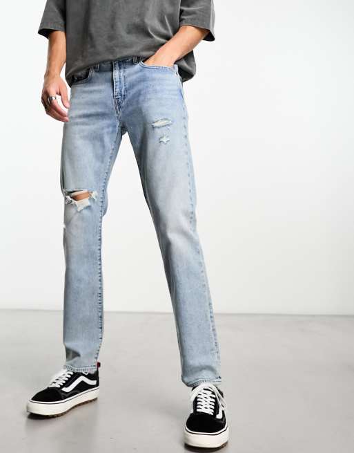 Levi s 502 tapered fit jeans in light blue wash with rips