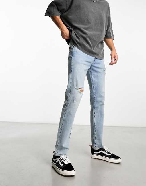 Levi s 502 tapered fit jeans in light blue wash with rips