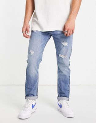 Levi's 502 tapered fit jeans in light blue with distressing