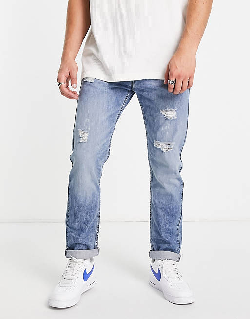 Levi's 502 tapered fit jeans in light blue with distressing | ASOS