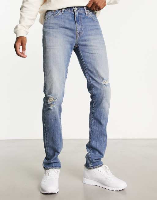 Levi s 511 slim fit jeans in light blue vintage wash with destruction