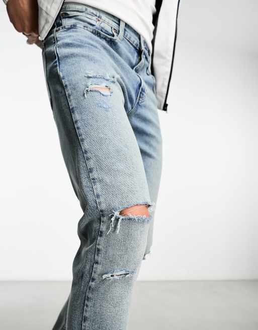 Levi's 512 slim taper jeans in light blue wash with knee rips