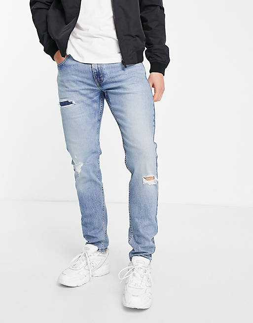 Levi's 512 slim taper jeans with distressing in light blue wash 