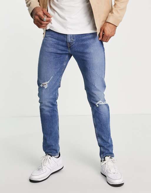 Levi's 512 slim taper lo ball jeans in blue with knee abraison | ASOS