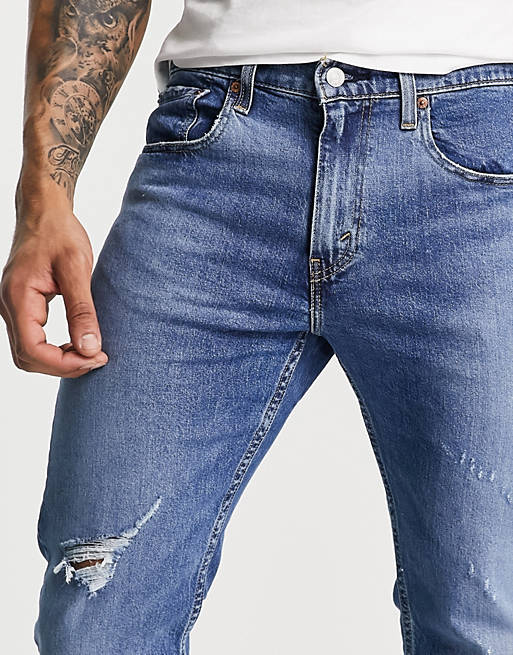 Levi's 512 slim taper lo ball jeans in blue with knee abraison | ASOS