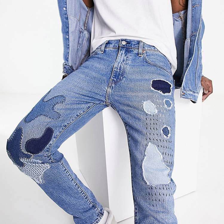 Levi's 512 slim tapered fit jeans in blue with patchwork and destruction |  ASOS