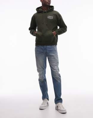 515 slim tapered fit distressed jeans in mid wash-Blue