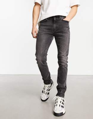 Levi's skinny tapered fit jeans in black with destruction - ASOS Price Checker