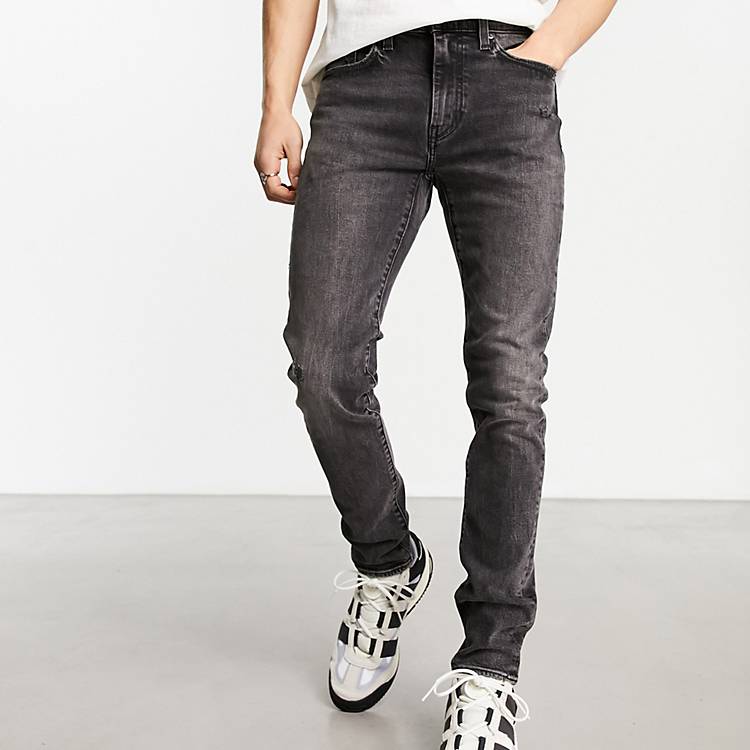 Levi's skinny tapered fit jeans in black with destruction | ASOS
