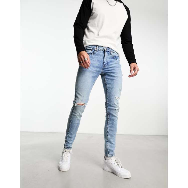 Levi s Skinny tapered fit jeans in light blue wash with distressing