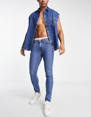 Levi's skinny tapered fit jeans in mid blue wash - ASOS Price Checker